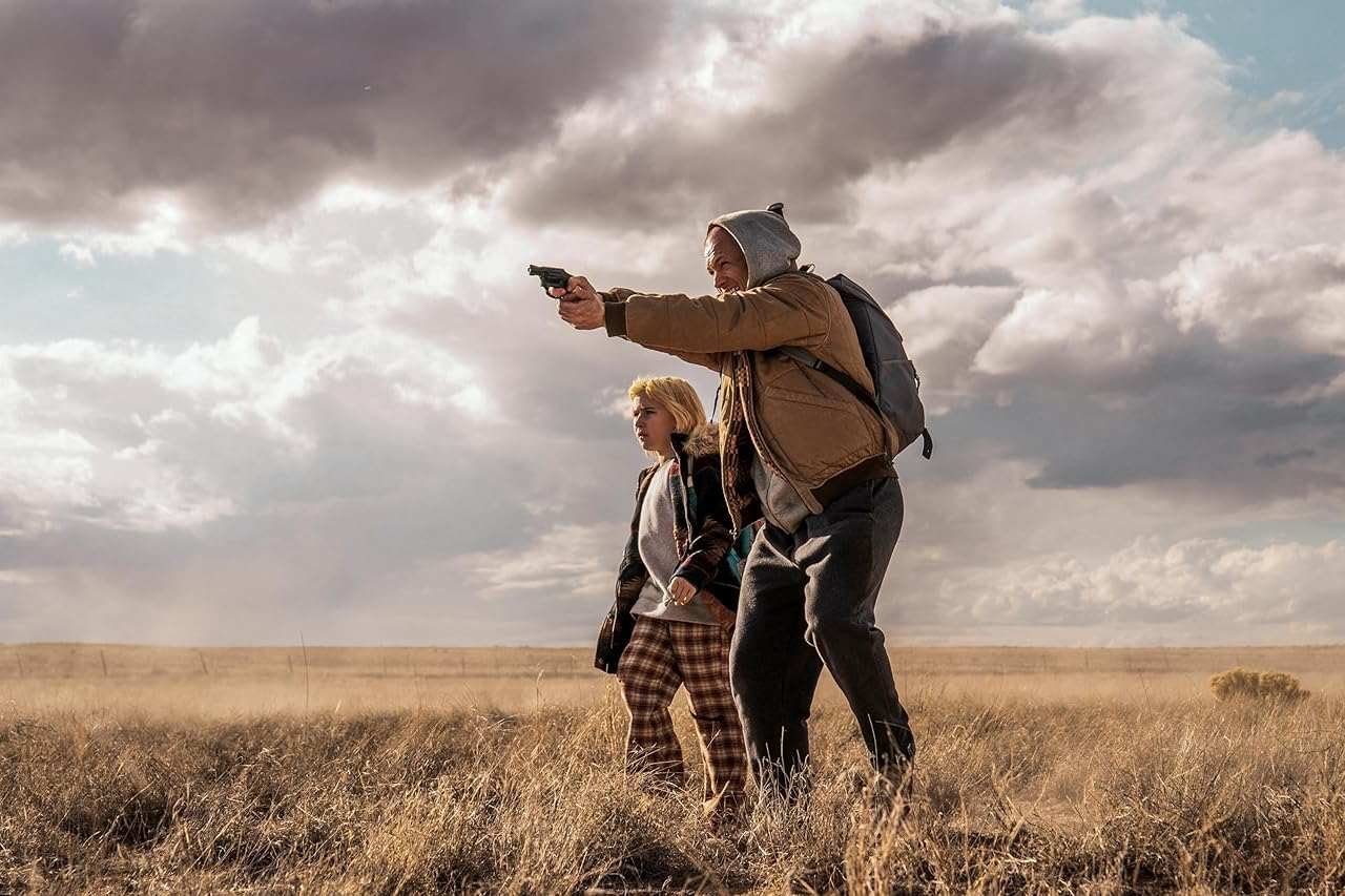 Taron Egerton and Ana Sophia Heger in She Rides Shotgun (2025)